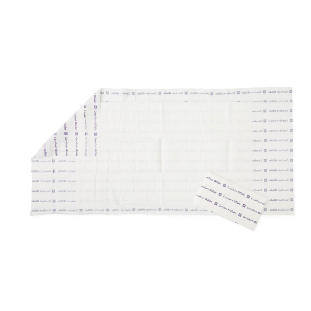 The Medline ComfortGlide Drypad Underpads - XL are rectangular sheets with a grid pattern and purple text, shown with one corner partially peeled back and a separate piece beside it, ideal for skin integrity and moisture management.